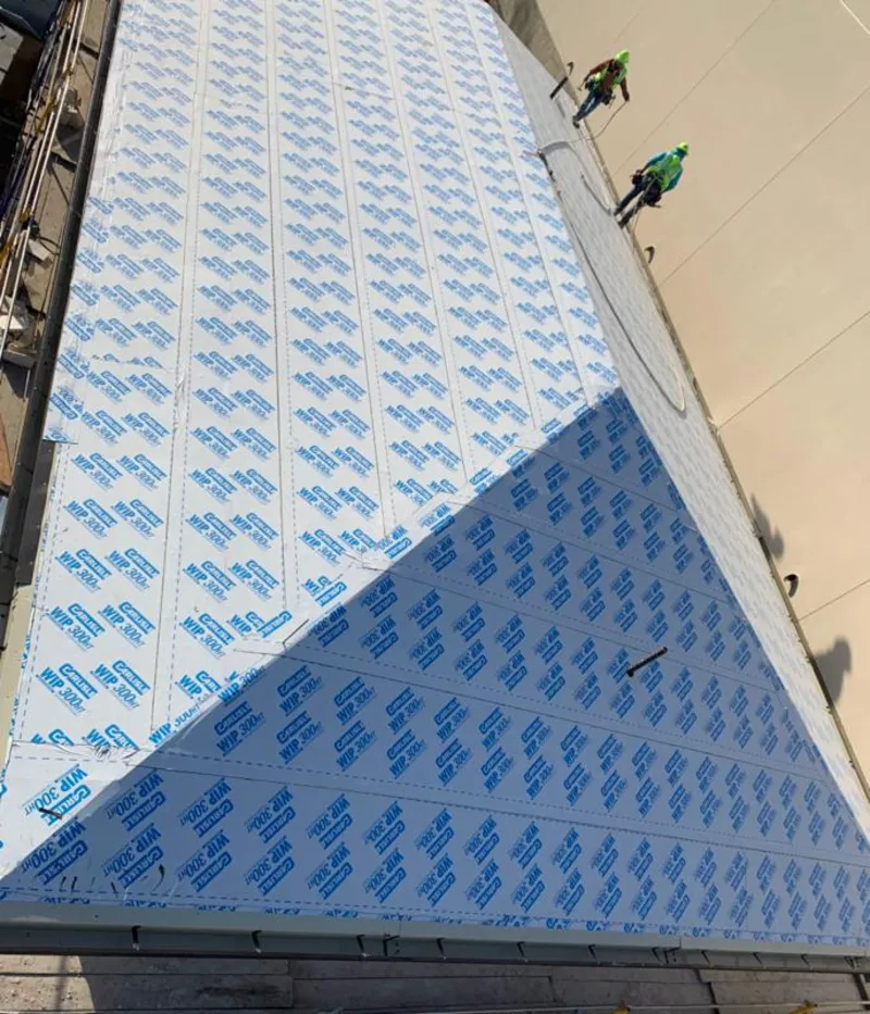 Professional roofers installing underlayment on a metal roof in Summit Park